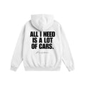 White hoodie with text 'All I Need is a Lot of Cars' on the back against a white background